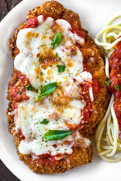 Crispy, saucy and cheesy, this chicken parmesan has loads of garlic-y flavor, and comes complete with an easy, homemade chunky marinara sauce! | thecozyapron.com #chickenparmesan #chickenparmesanrecipe #chickenparmesanrecipeeasy #chickenparmesaneasy #chicken Chunky Marinara Sauce, Magnolia Table Recipes, Joanna Gaines Recipes, Chicken Parmesan Recipe Easy, Chicken Parmesan Casserole, Easy Chicken Parmesan, Baked Chicken Parmesan, Crusted Chicken, Chopping Block