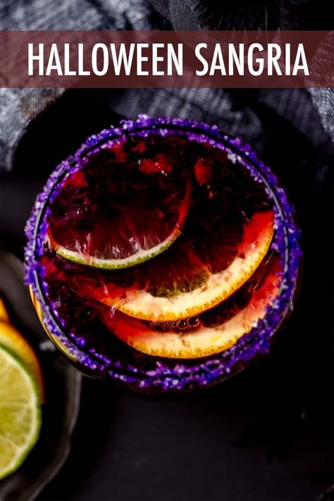 This spooky Halloween sangria is made with seasonal fruit, garnished with a colorful sugar rim, and is the perfect addition to your Halloween party spread. via @frshaprilflours Halloween Sangria Recipes, Halloween Drinks For Adults, Red Sangria Recipes Easy, Sangria Recipes Easy, Halloween Sangria, Halloween Drink Recipes, Blackberry Sangria, Halloween Recipes Drinks, Red Sangria Recipes