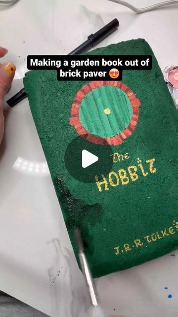 Welcome to the world of books! 🌹 on Instagram: "By @melanimichelleart : Making a garden book out of brick paver 😍 #mybookgramm #booksbrat  : : : : : : : #bookart #bookalcoholic #bookaddicted #booksbooks #bookarts #bookartist #vscoreads #vscobooks #booksonbooks #ilovetoread #readingismagic #booksarelove #readingismyhappyplace #readingisfun #readingismagic #fortheloveofbooks #library #libraries #fortheloveofbooks #bookbloggersofinstagram #bookcollector #beautifulbooks #beautifulbook" Hobbit Book, Garden Pavers, Yard Inspiration, Brick Art, Brick Garden, Bricks Diy, Brick Pavers, Handy Dandy, Painted Brick