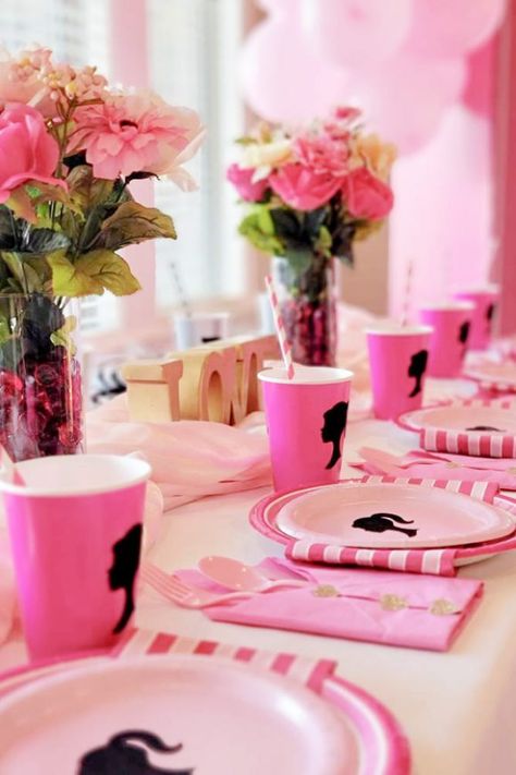 The pink Barbie silhouette papers plates and cups are totally on-theme and will elevate your Barbie birthday party to another level. The gorgeous floral arrangements are the perfect party decoration and will make your table settings so pretty. See more party ideas and share yours at CatchMyParty.com Centerpieces For Barbie Party, Barbie Office Party, Barbie Theme Table Set Up, Barbie Party Table Setting, Barbie And Ken Birthday Party Theme, Barbie 21 Birthday Party, Barbie Table Centerpieces Ideas, Barbie Birthday Favor Ideas, Barbie Themed Table Decor