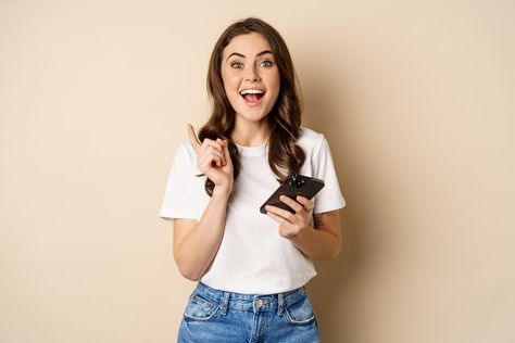 Free Photo | Enthusiastic woman holding smartphone and laughing, found smth online, concept of shopping and cellular technology Concept Shop, Beige Background, Photo Reference, Young Woman, Free Photo, Free Photos, Smartphone, Technology, T Shirts For Women