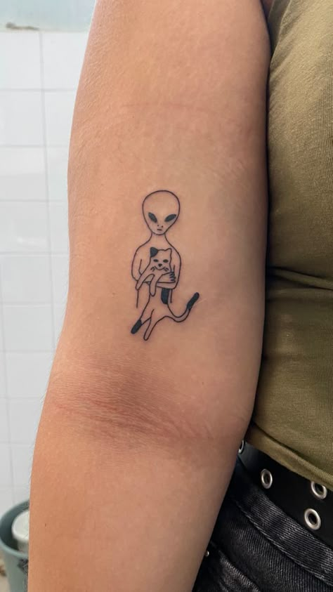 alien, cat, tattoo, cool, unique, line tattoo Cat Spaceship Tattoo, Alien Line Tattoo, Alien And Cat Tattoo, Cow Cat Tattoo, Girly Alien Tattoo, Weird Cat Tattoo, Alien Finger Tattoo, Cat Astronaut Tattoo, Matching Alien Tattoos