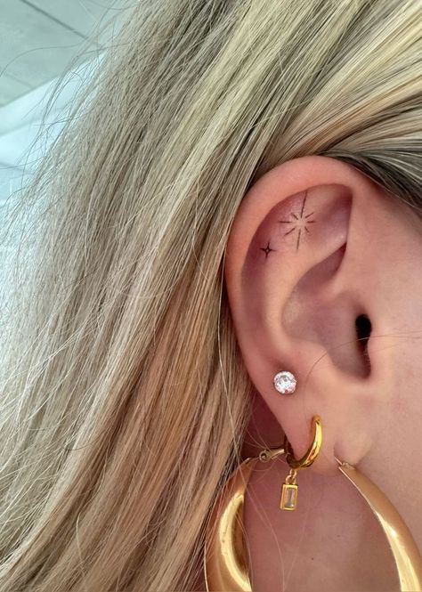 Ear Tattoo Sparkles, Sparkle Ear Tattoo, Star Tattoo On Ear, Ear Tattoo Piercing, Designed Ear Piercings, Dot Ear Tattoo, Uv Ear Tattoo, Tragus Ear Tattoo, Tattoo On Ear Cartilage