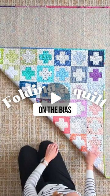 301K views · 17K likes | Shelly Moore on Instagram: "If you've ever heard someone say "you should fold your quilts on the bias" but didn't know what that meant (or if you should bother), then you'll want to check this out!

It's a simple and easy technique that anyone can do, and it will preserve and protect your quilts for the future. Don't have a huge living room floor? Lay your quilt out on a bed!

Want to learn more? Comment "FOLD" below and I'll send you a link to my full-length YouTube tutorial (where you can easily pause, rewind, and slow down the playback). 🎥

Quilt pattern: #scrapstashplusquilt (a free pattern) by @emily_dennis_" How To Fold A Quilt For Gift, How To Fold A Quilt For Display, How To Fold A Quilt For Storage, Folding Quilts For Storage, How To Fold A Quilt, Folding Quilts, Quilt Hacks, Huge Living Room, Quilting Math