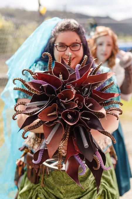 Steampunk bridal bouquet with leather and tentacles | Misfit Wedding blog Steampunk Floral Arrangements, Pirate Bouquet, Leather Wedding Bouquet, Octopus Wedding, Steampunk Wedding Decorations, Steampunk Flowers, Mermaid Flowers, Steampunk Wedding Dress, Steampunk Wedding Ideas