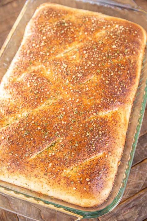 Family Style Calzone - this casserole is a favorite at our house. It is super simple to make and everyone loves it! Pizza dough stuffed with ricotta, mozzarella, parmesan, and your favorite pizza toppings and baked. Top the baked calzone with some warm spaghetti sauce and prepare to be wowed! Serve with a simple salad and you are set! Uses For Pizza Crust, Sheet Pan Calzone, Calzone Dough Recipe Easy, Pizza Dough Calzone Recipe, Spaghetti Calzone, What To Make With Pizza Dough, Calzone With Pizza Dough Pillsbury, Calzone Using Pillsbury Pizza Dough, Homemade Calzone Recipe With Pizza Dough