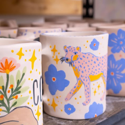 The first batch of bisque mugs is out of the kiln and here’s some snippets of their designs. They still need to be glazed so I won’t spoil the surprise but I’m really excited about these babies 🌸💕☕️✨ #potterylife #potterystudio #mugs #mugsofinstagram #coffeemug #potterylife #handmadeceramics #handmadeceramic #underglaze Paint Plant Pot Ideas, Mug Art Paint, Ceramic Painting Mug, Diy Ceramic Painting, Pottery Art Painting, Pottery Painting Inspiration, Underglaze Painting On Pottery, Underglaze Pottery, Mug Design Ideas