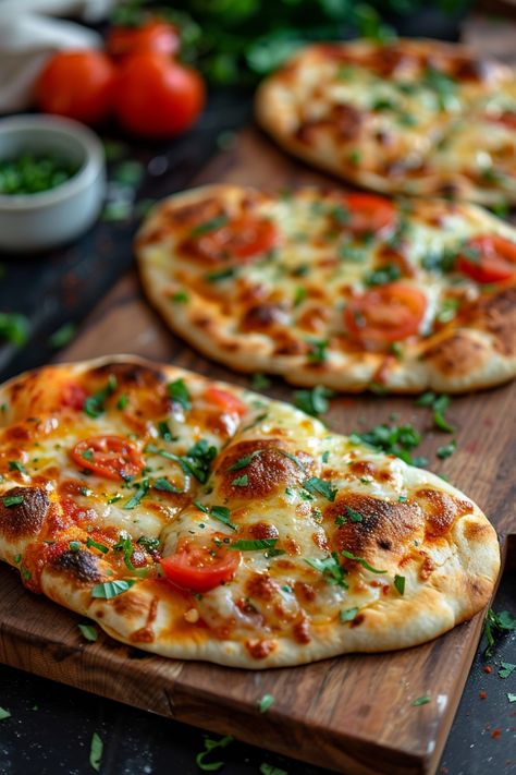 Three freshly baked naan flatbreads topped with melted cheese, cherry tomatoes, and fresh herbs on a wooden board. Naan Bread Ideas Healthy, Naan Appetizer Recipes, Flatbread Pizza Air Fryer, Mini Naan Bread Ideas Appetizers, Naan Recipe Ideas Dinners, Naan Pizza Oven, Naan Bread Pizza Air Fryer, Stonefire Naan Recipes, Pita Pizza Air Fryer