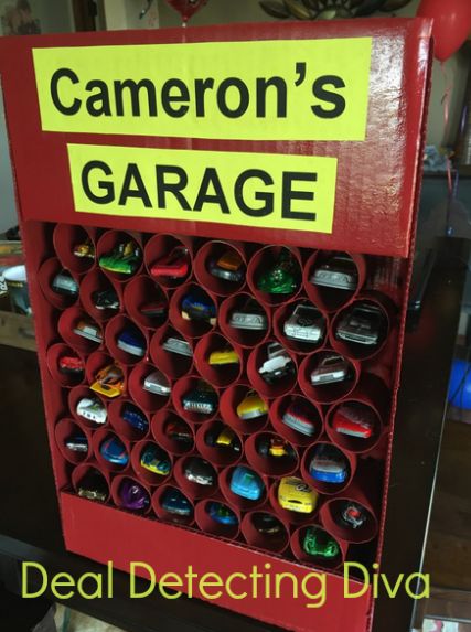 My youngest is a Hot Wheels freak. He’s got roughly three hundred of them dispersed throughout his room, so I decided to make him a little garage using toilet paper/paper towel rolls, hot glue and a cardboard box – all of which I had around the house – and a $1.64 can of spray paint … Kids Car Garage, Diy Toy Car, Hot Wheels Diy, Diy Toys Car, Hot Wheels Storage, Toy Car Garage, Diy Wooden Crate, Hot Wheels Garage, Toy Garage