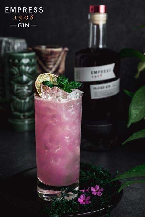 Spooky season is upon us and we're celebrating with the magical and moody Jungle Flower by @thewelltable! 🌺 To mix up at home, shake 2 oz Empress 1908 Gin, ¼ oz Orgeat (up to ½ oz if you like it sweeter!), ¾ oz Peach Schnapps, ¾ oz Pineapple Juice, ¾ oz Lime Juice, and 2 dashes Creole Bitters with ice. Strain into a glass filled with crushed ice, and garnish with fresh or dehydrated lime and fresh mint. Moonshine Recipes Homemade, Empress Gin, Empress 1908 Gin, Gin And Soda, Citrus Garnish, White Cranberry Juice, Cocktail Maker, Jungle Flowers, Happy Drink