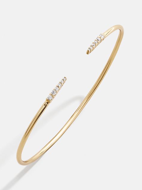 The Rima 18K Gold Cuff Bracelet is your solution to one-and-done bracelet styling. This delicate cuff is meant to show the negative space on the top of your wrist, highlighting the pointed ends and considered detail. Even better, this piece is crafted with 18K gold plated sterling silver, ensuring high shine for years to come.