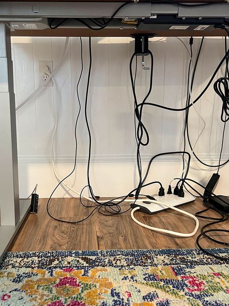 How To Hide Cords On A Standing Desk – A Pretty Happy Home How To Hide Cords On Front Facing Desk, Hiding Office Cords, Hiding Monitor Cords Computer Desks, Cord Management Desk, Computer Wire Organization Hiding Cords, Home Office Hide Cords, Cable Management For Standing Desk, Cord Hiding Ideas Desk, Hiding Cords On Desk In Middle Of Room