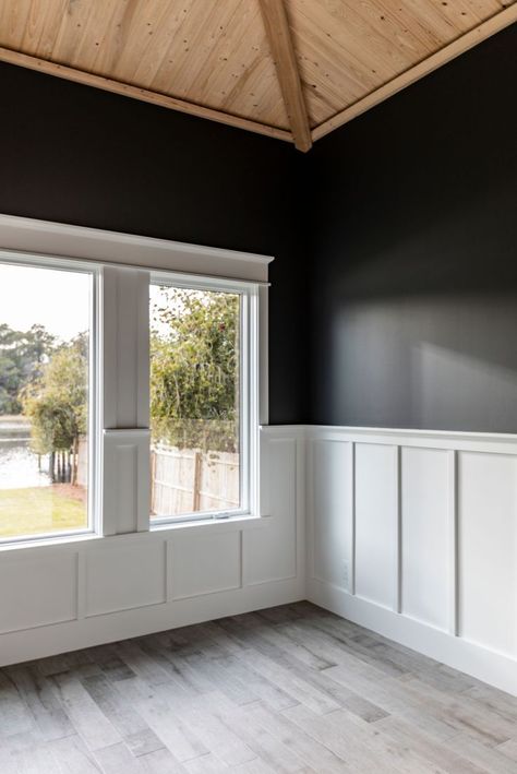 Vaulted wood ceiling with black painted walls and a white trim chair rail White Beadboard Black Walls, Walls With Middle Trim, Black Walls With Chair Rail, Craftsman Style Chair Rail, Modern Chair Rail Bedroom, White Chair Rail Dining Room, Wainscoting With Picture Rail, Black Wall With White Wainscotting, Dark Wall With Wainscotting