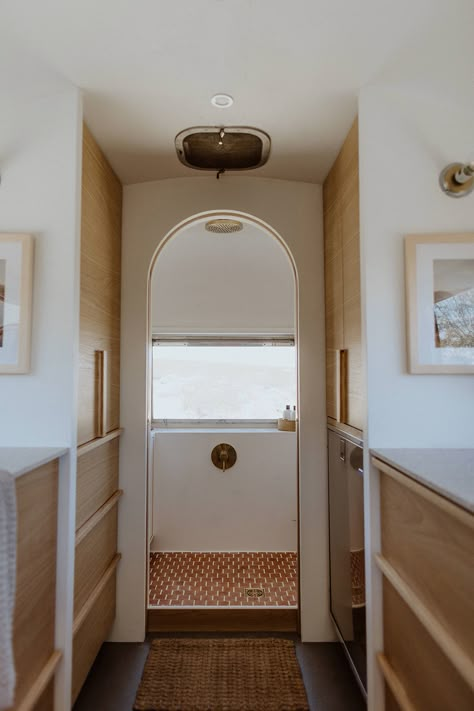 This Renovated Airstream Looks Like a Luxury California Chic Home The Modern Caravan, Airstream Remodel Bathroom, Airstream Fireplace, Airstream Shower Remodel, Argosy Airstream Remodel, Airstream Closet, Bus Renovation Interiors, Air Stream Remodel Interiors, Argosy Interior