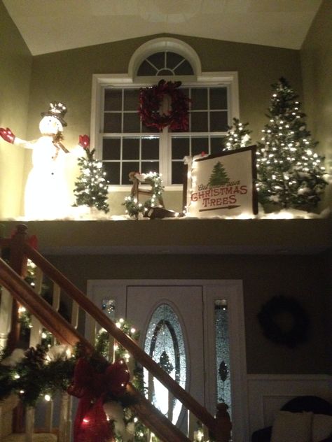 Christmas plant ledge Plant Ledges Living Room, Large Window Ledge Decor, Alcove Christmas Decor, Plant Ledge Christmas Decorating, High Shelf Christmas Decorating, Foyer Ledge Decorating Ideas Christmas, Ledge Above Front Door Decorating, Christmas Ledge Decorations, Christmas Ledge Decorating Ideas