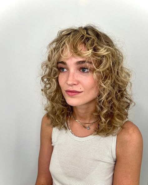 When it comes to hairstyles that effortlessly blend style and ease, few can rival the allure of curly shaggy hair. This iconic look has made a signifi... Blonde Balayage Grey Coverage, Short Curly Blonde Balayage, Curly Hairstyles Shag, Short Curly Hairstyles Blonde, Short Blonde Curly Hair With Bangs, Shaggy Bob Hairstyles Curly Hair, Perm Shoulder Length Hair, Short Curly Balayage Hair, Short Naturally Wavy Hair