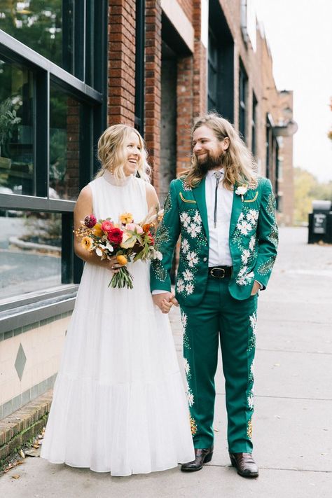 Jimmy + Meghan's Country Music inspired wedding ensembles featured a custom nudie suit and custom embroidered white denim jackets. | Image by Sarah Murray Photography #creativeweddingideas #eclecticweddingideas #greenweddingtuxedo Non Traditional Wedding Tuxedos, Embroidered Wedding Suit Men, Mens Alternative Wedding Attire, 70s Groom Suit, Unique Wedding Suits, Embroidered Wedding Suit, Unique Groomsmen Attire, Country Groom Attire, Music Inspired Wedding