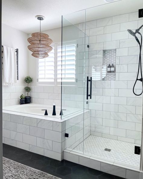 This white bathroom boasts a white and gray marble tiled drop-in tub with black faucet. A seamless glass and matching marble tile shower next to the tub features a marble hexagon tile niche and black shower kit. Tub Next To Shower Ideas, Bathroom With Marble Tile, Tile Niche, Bathroom With Marble, Tile Tub, Bathroom With Tub, Master Bath Shower, Hexagon Tile, Black Faucet