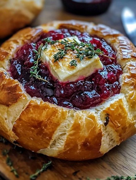 🧀 Baked Brie in Bread Bowl with Cranberry Sauce and Thyme  Ingredients:  Round loaf of bread (like sourdough) Brie cheese wheel Cranberry sauce Fresh thyme Olive oil  Instructions:  Preheat oven to 350°F (175°C). Hollow out the center of the bread loaf and place the Brie inside. Spread cranberry sauce over the top, sprinkle thyme, and drizzle olive oil. Bake until Brie is melted and gooey. Serve warm with bread chunks or crackers.  Prep Time: 10 mins | Total Time: 25 mins | Servings: 6 ￼ Baked Brie In Bread Bowl, Baked Brie In Bread, Bread Bowl Dip, Brie Recipes Appetizers, Cheese Wheel, No Cook Appetizers, Brie Recipes, Cranberry Sauce Recipe, Thanksgiving Cooking