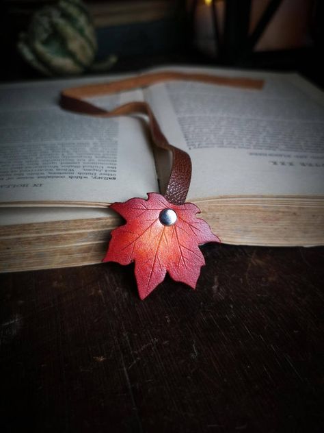 A flurry of fall color to carry throughout the year. This lovingly crafted leather maple leaf bookmark will see you through a lifetime of adventure. Uniquely hand carved, the leather leaf is securely riveted to soft and supple recycled leather that sits perfectly between the pages of your favorite