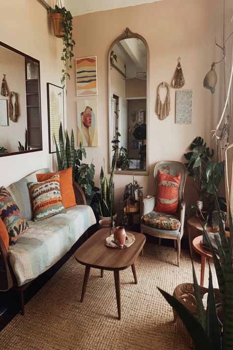 A beautifully styled living room with a bohemian aesthetic, featuring warm earthy tones. The space is adorned with vibrant throw pillows, lush greenery, and a cozy seating area. The combination of natural textures and unique wall art enhances the inviting and eclectic vibe. #bohemianlivingroom #cozyhomedecor #earthytones #bohostyle #bohochic #indoor plants #eclecticdecor #throwpillows #wallart #naturaltextures Spanish Revival Interior Living Room, Hippie Living Room, Spanish Revival Interior, Bohemian Aesthetic, Bohemian Living Room, Vintage Hippie, Cozy Living Rooms, Unique Wall Art, Earthy Tones