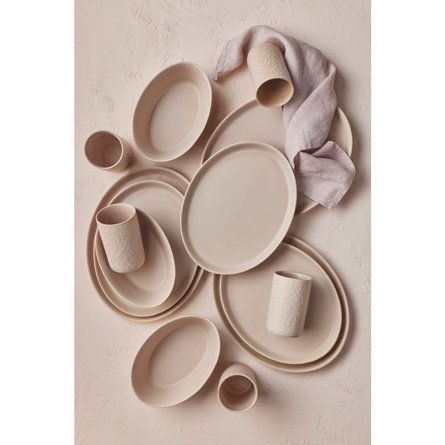 Stone by Mercer oval collection is a 16 pieces stoneware dinnerware set. The oval dish set includes four dinner plates (12.2 x 9.6 inches), four salad plates (10.8 x 8.5 inches), four bowls (19.6 fluid ounces), and four cups (10.8 fluid ounces). The beige and pink hues highlight the outside texture and shape of each dish to give a unique and aesthetically pleasing look. The collection standout for its unusual shape and has stackable plates and bowls for easy storage. Although dishwasher and micr Stoneware Dinner Sets, Soft Contemporary, Stoneware Dinnerware Sets, Modern Eclectic, Stoneware Dinnerware, Notes Inspiration, Kitchen Decorating, Dining Sets, Disposable Tableware