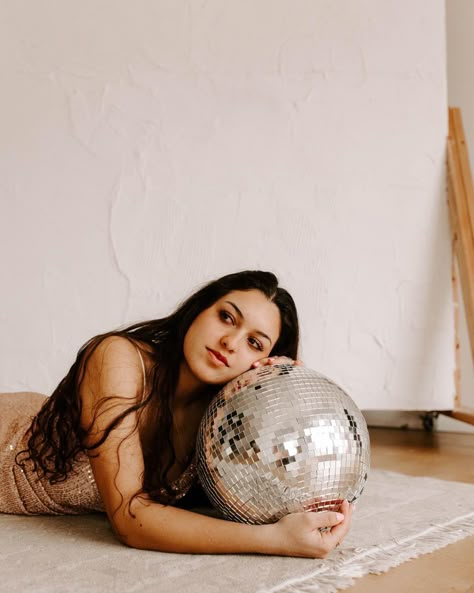 Girl rests her head on disco ball Disco Ball Studio Photoshoot, Disco Ball Branding, Disco Ball Photo Shoot, Discoball Photoshoot Ideas, Fun Studio Photoshoot Ideas Creative, Ball Pit Photoshoot, 70s Witch, Disco Shoot, Disco Ball Photoshoot