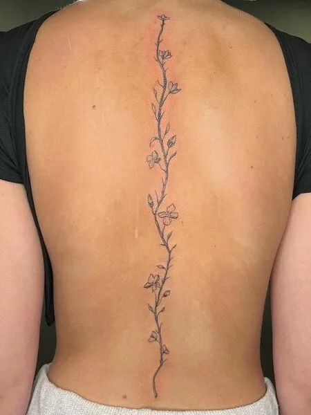 Cherry Blossom Spine Tattoo Back Tats Women Cherry Blossom, Flower Vine Tattoo On Back, Flower Vine Tattoo Down Spine, Flowers Up Spine Tattoo, Flower Vine Spine Tattoos For Women, Simply Spine Tattoo, Bottom Spine Tattoo, Petite Spine Tattoos, Back Tattoo Women Simple Spine