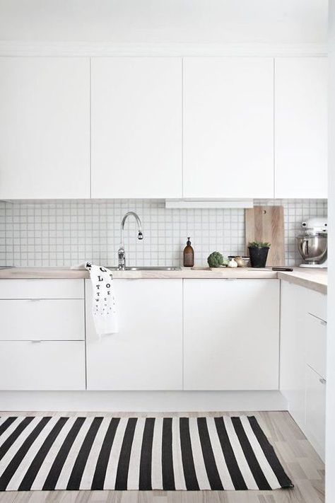 This white #kitchen looks straight out of a #Scandinavian dream. The simple stack tile and the soft color of the counters make it easy on the eyes and I'm sure a joy to cook in! #ThisOldHouse inspiration via www.L-2-Design.com Dapur Skandinavia, Minimalist Dekor, Scandinavian Kitchen Design, Kabinet Dapur, Kitchen Wood, Minimalist Kitchen Design, White Kitchen Design, Subway Tiles, Scandinavian Kitchen