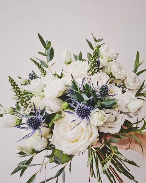 Flowers On Wedding Aisle, Bouquet With Blue Thistle, Blue Winter Wedding Centerpieces, Wedding Bouquets With Forget Me Nots, Bridal Bouquet With Blue Thistle, Winter Wildflower Bouquet, Bridal Bouquet Thistle, March Wedding Bouquets, Botanical Wedding Bouquet