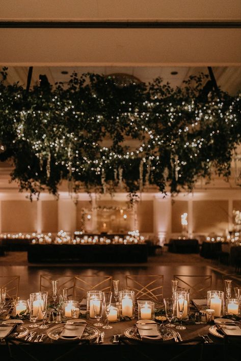 Glowy evening wedding reception with stunning lush greenery installation and romantic candlelit tablescapes at elegant ballroom bash at Nemacolin in Farmington, Pennsylvania. Dream turned reality by Florist- Luxe Creative, Planner- Bumble Burgh Events Co. and Photographer- Rachel Rowland. Romantic Evening Wedding Decor, Wedding Ballroom Lighting, Wedding Ballroom Decorations Receptions, Romantic Greenery Wedding Decor, Lush Romantic Wedding, Twinkle Lights Ballroom Wedding, Ballroom Wedding Reception Romantic, Dark Ballroom Wedding, Winter Wedding Ballroom