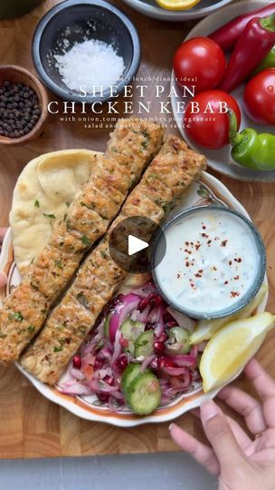 201K views · 18K reactions | Sheet Pan Chicken Kebab with Onion, Tomato, Cucumber Pomegranate Salad and Garlic Yogurt Sauce

Minced Chicken Kebab:

Ingredients:

- 2 lbs boneless, skinless chicken thighs, minced
- 1 large red onion, finely chopped and squeezed
- 1-2 jalapeños, finely chopped
- 8-9 cloves fresh garlic, minced
- 1 tbsp freshly minced parsley
- 2 tbsp tomato paste
- Salt, to taste
- 1 tsp black pepper
- 1 tbsp garlic powder
- 1 tbsp onion powder
- 1 tsp ground cumin
- 1 tsp red chili flakes
- 3 tbsp oil

For the Onion, Tomato, Pomegranate Salad:

Ingredients:

- 1 cucumber, sliced
- 1 red onion, sliced
- 1 large tomato, seeded and finely chopped
- 1/2 cup pomegranate seeds
- 1 tbsp freshly chopped parsley
- Salt, to taste
- 1 tsp sumac
- 1 tsp lemon juice
- 2 tbsp olive oil Garlic Yogurt Sauce, Chicken Kabab, Garlic Yogurt, Minced Chicken, Chicken Kebab, Sheet Pan Chicken, Pomegranate Salad, Tomato Cucumber, Fish And Chicken