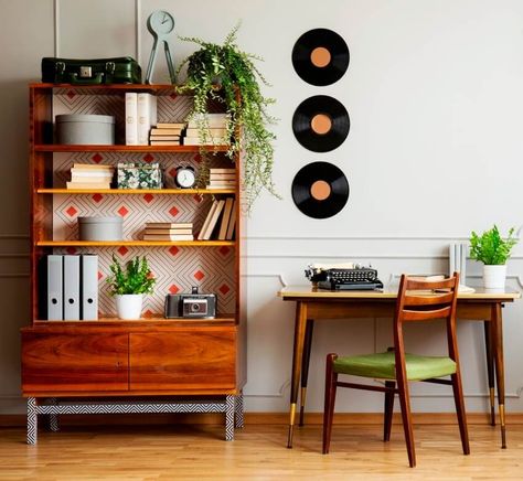 A black retro typewriter on a unique wooden desk a mid century modern chair and a renovated bookcase Vinyl Record Storage Box, Vinyl Record Shelf, Record Shelf, Vinyl Record Storage, Deco Retro, Mid Century Modern Decor, Furniture Hacks, Switch Plate, Small Wall