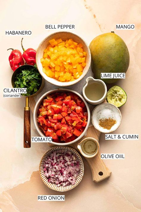 This homemade mango habanero salsa recipe is the perfect combination of sweet, spicy & tangy! Made using spicy habanero peppers, red onion, bell peppers, fresh cilantro & more, this spicy salsa will tickle your tastebuds like no other! All you need to do to make this flavorful salsa is chop the ingredients and stir them well! For best results, adjust the spice level to taste. This is crucial. Remember that habaneros are some of the hottest peppers out there. Start with one and add more. Habanero Peppers Recipes, What To Do With Habanero Peppers, Habanero Salsa Recipe, Habanero Recipes, Mango Habanero Sauce, Mango Habanero Salsa, Habanero Salsa, Pepper Salsa, Salsa Recipes