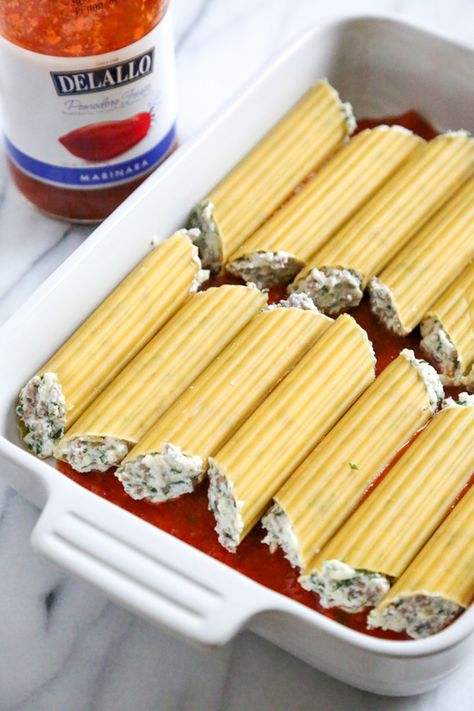 This easy no-boil baked manicotti pasta dish, known as Cannelloni is stuffed with ricotta, parmesan, mozzarella and lean ground beef, then covered in sauce and cheese. Perfect for the holidays, for to bring to a potluck or to enjoy any night of the week! Baked Cannelloni Recipe, Easy Stuffed Pasta Recipes, Pasta Cannelloni Recipes, Manicotti Recipe Beef Ricotta, Oven Baked Manicotti, Manicotti No Boil, Cheese Stuffed Rigatoni Pasta Bake, Baked Stuffed Manicotti, Beef And Cheese Manicotti Recipe