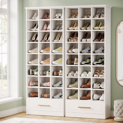 Standing at an impressive 71-inches tall and coated in a sleek white finish, this wooden shoe rack offers stylish storage solution to maintain a tidy entryway. Designed to hold up to 24 pairs of shoes, it features spacious cubbies that can accommodate a variety of shoe styles and sizes. Wildon Home® Finish: White | Wildon Home® 71-Inch Tall Shoe Storage Cabinet 70.87 H x 13.77 W x 25.59 D in brown / Manufactured Wood in White | 24 | Wayfair | Organization Shoe Rack Garage, Shoe Storage Ideas Entryway, Tall Shoe Storage, Garage Shoe Storage, Hallway Storage Cabinet, Wooden Shoe Rack, Wood Organization, Closet Shoe Storage, Shoe Rack Closet