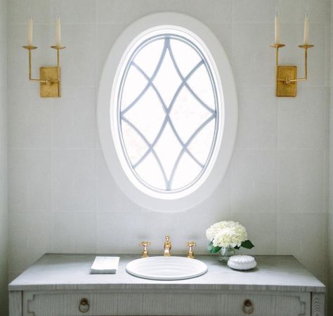 Oval leaded glass window over a gray French sink vanity in a transitional bathroom. Stained Glass Interior, Walden House, Oval Windows, French Country Bathrooms, Exterior Home Renovation, Small Powder Room Ideas, Country French Style, French Vanity, Arte Art Deco