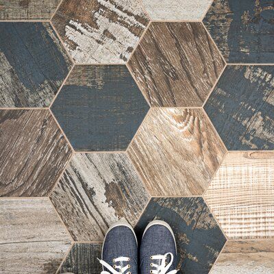 The tile is a breathtaking addition to our collection of wood-look tiles. Crafted in Spain, the brown glaze features a meticulously detailed grain accented in white, grey, and blue. To add further contrast and depth, this tile has a visible grain and knot design that echoes the look of real wood. The finishing touch on this hexagon is the imitations of scuffs and spots, which gives this tile an antiquated appearance reminiscent of distressed painted wood. This porcelain tile has 20 different pri Matte Tile, Merola Tile, Wood Look Tile, Porcelain Floor, House Tiles, Natural Stone Tile, Porcelain Flooring, Tile Samples, Wall And Floor Tiles