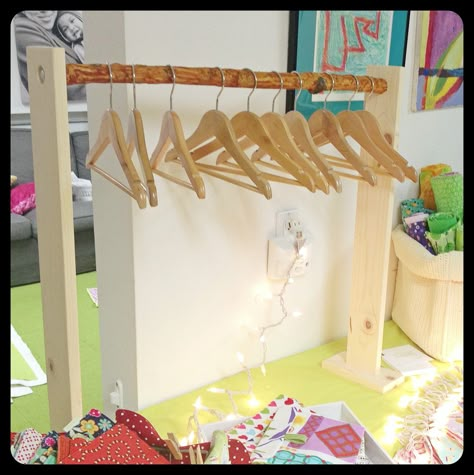 Easy branch rack for our craft show booth setup (table top). This is a mini one that holds small children's hangers, click on for a picture of the larger one. Display For Hanging Items, Market Stall Hanging Display, Diy Clothes Rack For Craft Show, Onesie Display Craft Fairs, Craft Fair T Shirt Display, Table Runner Display Craft Show, Tabletop Hanging Display, Craft Fair Hanging Display, Display Hanging Items Craft Booths