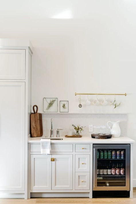 One feature we try to sneak into every home design is a wet bar - perfect for everyday coffee prep, or occasional entertaining, coffee bar, wet bar, beverage fridge, wine fridge, cocktail glasses, cocktail accessories, wet bar faucet, prep faucet, wall art, towel bar  Follow my shop @Thedendesigngroup on the @shop.LTK app to shop this post and get my exclusive app-only content!  #liketkit #LTKStyleTip #LTKHome #LTKFamily @shop.ltk https://liketk.it/4SucQ Coffee Bar Next To Fridge, Wine Fridge Cabinet, Small Wet Bar, Greige Kitchen, Beverage Fridge, Shaker Style Cabinets, Bar Faucet, Revere Pewter, Beverage Refrigerator