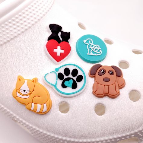 Check out other fun charms at my Etsy shop! One low shipping charge no matter how many you purchase! https://etsy.me/3bqH6xp Veterinarian shoe charms Vet Charms Cat charm Dog Charm Perfect gift for Vet or Vet Tech Week Fast shipping via 1st class USPS package with tracking. Thanks for looking! Use these charms to create personalized clogs, or to make unique items such as pencil or pen toppers, charm keychains, cake toppers or anything else you can think of! All charms are shipped with button on Vet Tech Shoes, Vet Assistant Accessories, Diy Vet Tech Gifts, Vet Tech Week Gifts, Vet Tech Tumbler Ideas, Charm Keychains, Vet Tech Week, Pen Toppers, Staff Motivation