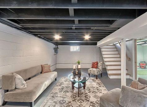 An unfinished basement, with its concrete floor and exposed joists, may seem… #basementflooring Unfinished Basement Ceiling, Exposed Basement Ceiling, Basement Ceiling Painted, Basement Ceiling Options, Basement Suite, Low Ceiling Basement, Basement Painting, Ceiling Options, Basement Lighting