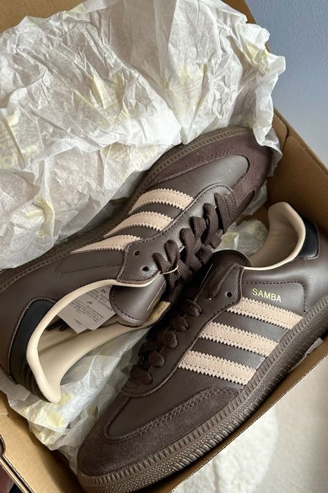 The new Adidas Sambas in Earth Stratum are ideal for fall fashion due to their versatile, muted tones that complement autumnal palettes. The rich chocolate , earthy color enhances a range of outfits, from casual denim to layered looks. Crafted from high-quality materials, they provide both comfort and durability, making them perfect for cooler weather. Their classic silhouette adds a retro vibe, effortlessly blending with contemporary styles. Additionally, the iconic design ensures they remain a timeless staple, allowing for seamless transitions from day to night. Overall, these sneakers encapsulate both style and functionality, making them a fall essential. Adidas Sambas, Adidas Samba Og, Chic Shoes, Early Fall Outfit, Fashion Toys, Dream Shoes, Adidas Samba, Casual Denim, Sporty Style