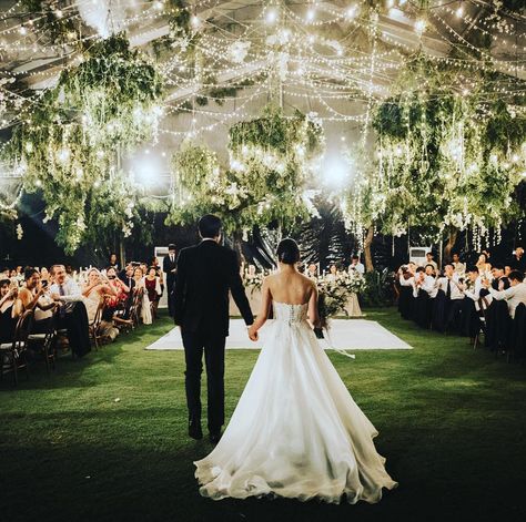 Loving the fairy lights dancing like stars above our couple as they make their grand entrance for dinner, the transparent marquee glows… Majorca Wedding, Wedding Gardens, Marquee Lighting, Transparent Tent, Marquee Decor, Reception Ceiling, Wedding Tents, Romantic Wedding Receptions, Bali Wedding