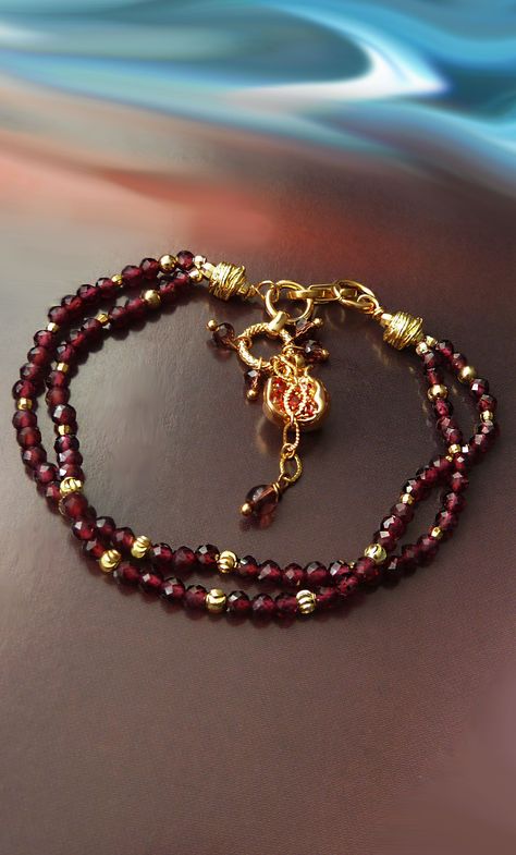 The garnet bracelet features two strands of 3 mm natural garnet beads adorned with finely crafted pomegranate good luck charm. GARNET: * Passion * Romantic love * Positive thoughts * Positive energy * Inspiration * Success * Self-confidence POMEGRANATE: * Beauty * Love * Marriage * Fertility * Birth * Hope * Prosperity Garnet Beads Jewelry, Pomegranate Bracelet, Energy Inspiration, Garnet Bead Bracelet, Pomegranate Jewelry, Jewellery Board, Diy Armband, Garnet And Gold, Jewelry Bracelets Gold