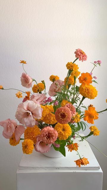 Marigold And Zinnia, 60s Flower Arrangements, Orange Flower Decorations, Yasmine Mei Floral Design, Marigold Wedding Centerpieces, Cosmos And Marigold Bouquet, Cempasuchil Flower Arrangement, Marigold Flowers Wedding, Pink Yellow Orange Flower Arrangement