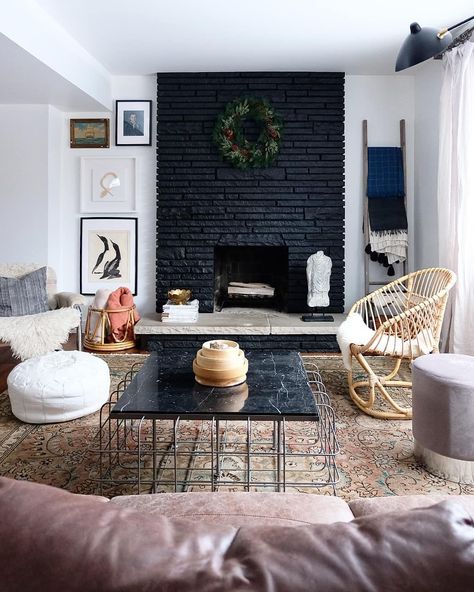 Black painted fireplace with natural stone hearth and simple wreath, Love how dramatic it is! Black Brick Fireplace, Painted Fireplace, Brick Fireplaces, Painted Brick Fireplace, Painted Brick Fireplaces, Paint Fireplace, Black Fireplace, Brick Fireplace Makeover, Fireplace Remodel