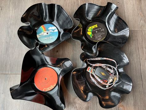 "Looking for a gift for someone you NEVER know what to get them?  HERE IT IS! These are 12\" vinyl records from the 30's through the 80's. All records are unusable and have been taken and upcycled into something cute and usable.  Each bowl is unique and no two bowls are the same.  Unfortunately, I cannot take requests for certain records, all record labels are random. I can in some cases help with some requests, ie color and shape.  THESE ARE NOT FOR FOOD CONSUMPTION! You can use these for just about anything else. Keys, wallets, spare change, odd and ends, and so many other things. All sales are final. If you have a problem with your order, please message the page." Thrift Diy Upcycling, Things To Do With Records Vinyls, Things To Do With Records, Upcycling Aesthetic, Grunge Apartment Aesthetic, Vinyl Record Bowl Diy, Melted Record Bowl, Odd Decor, Vinyl Record Sculpture