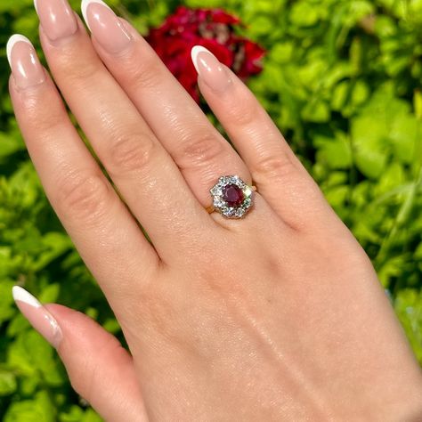 New in! A glorious antique Edwardian ruby and diamond cluster ring adorned with a natural oval-cut ruby in the centre with a deep cherry-pink hue. It weighs approx. 0.80ct and is complemented by eight bright diamonds, totalling approx. 0.80ct as well. The diamonds are all brilliant-cut, except one old mine-cut that may have been added over time. The piece is all 18ct with a white gold gallery and yellow gold back and band. It dates to the early-1900s and would make a stunning antique engage... Gold Gallery, Diamond Cluster Ring, Diamond Cluster, Early 1900s, Cluster Ring, Oval Cut, Dates, Ruby, Cherry