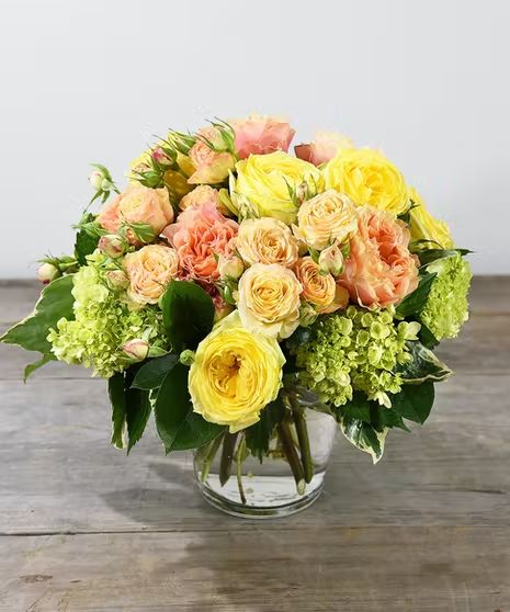 A lush and beautiful collection of cheerful premium garden and spray roses in hues of yellow, pink, whites and sometimes lavender roses are accented with green hydrangea designed in a classic glass vase. Simply lovely. #AhSamFloralCo Summer Flower Arrangements, Birthday Bouquet, Green Hydrangea, Flowers Delivered, Blooming Plants, Orchid Plants, Lavender Roses, Language Of Flowers, Spray Roses